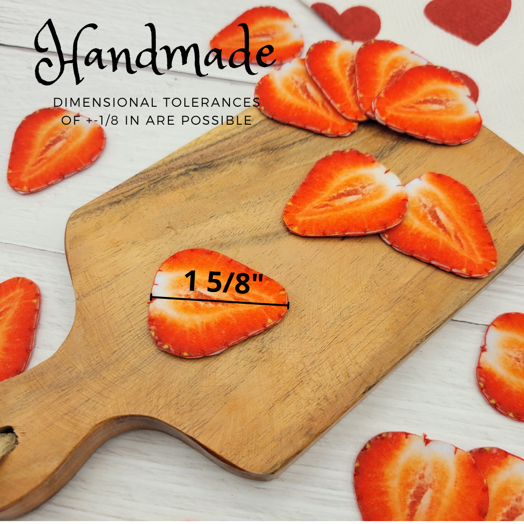 Wooden cutting board with strawberry plush food toy slices and measurement text on a light wooden background.