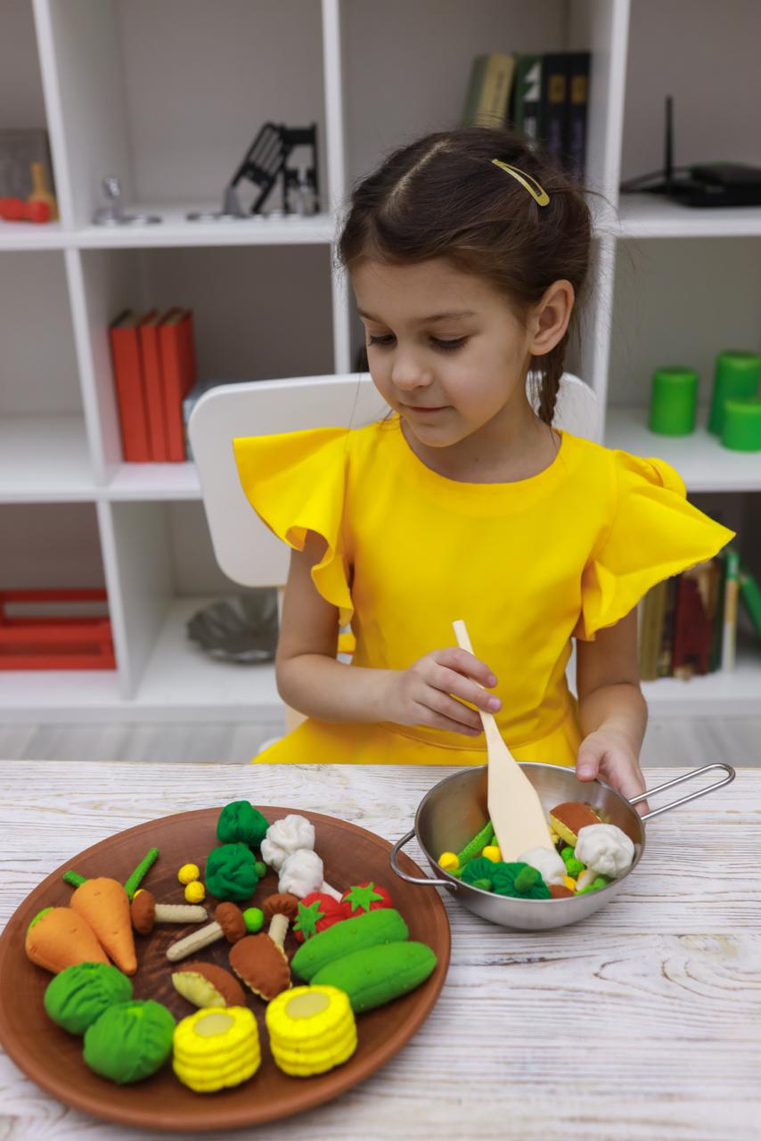 Children playing with vegetables plush toy set