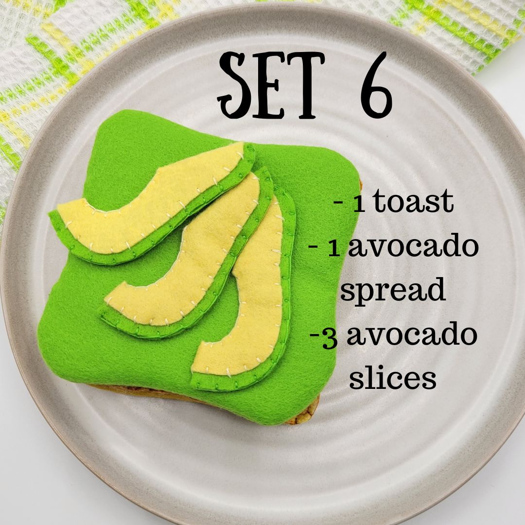 Felt food set with green avocado toast, avocado spread, and slices on a white plate.