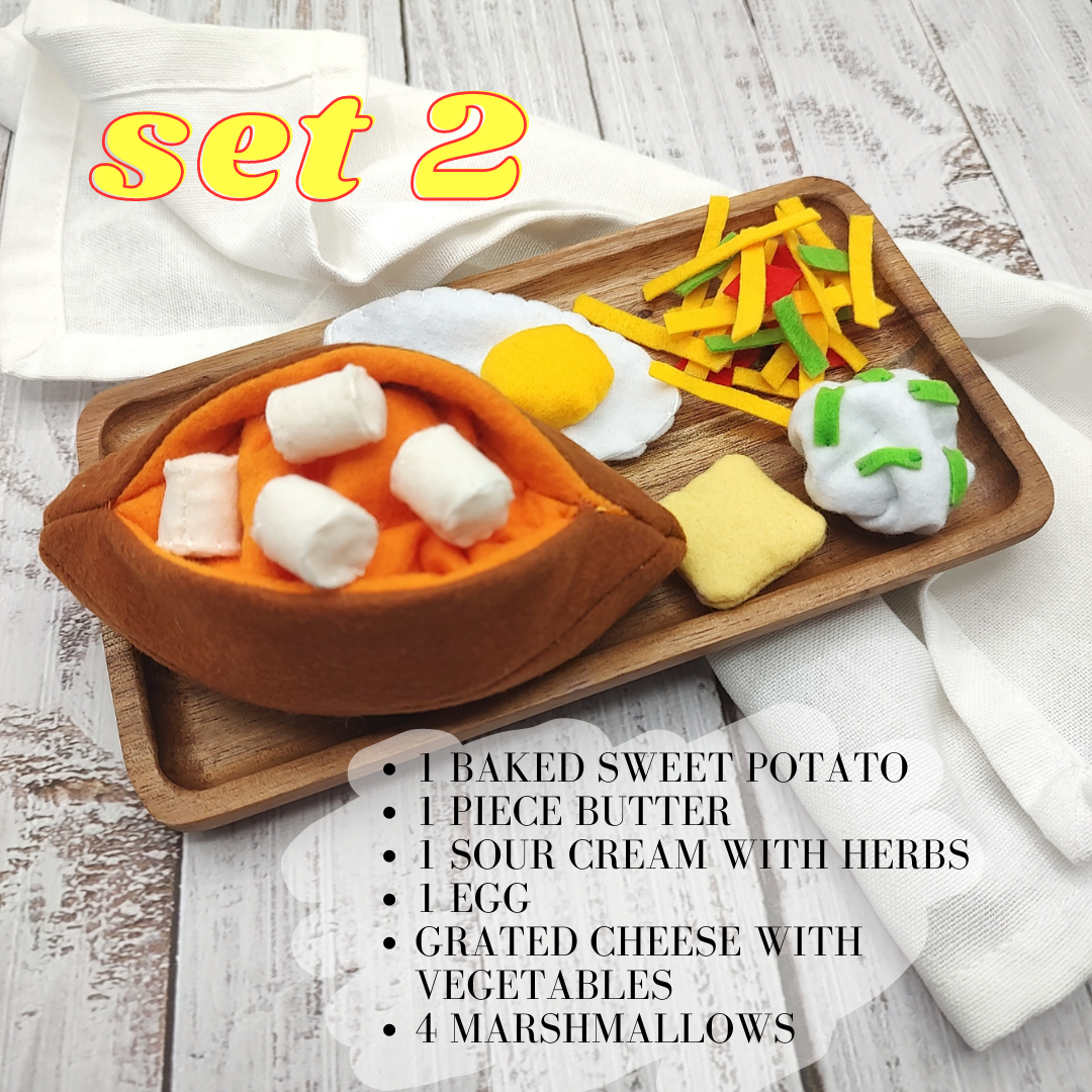 Wooden tray with toy food items on a white surface, labeled 'set 2'.