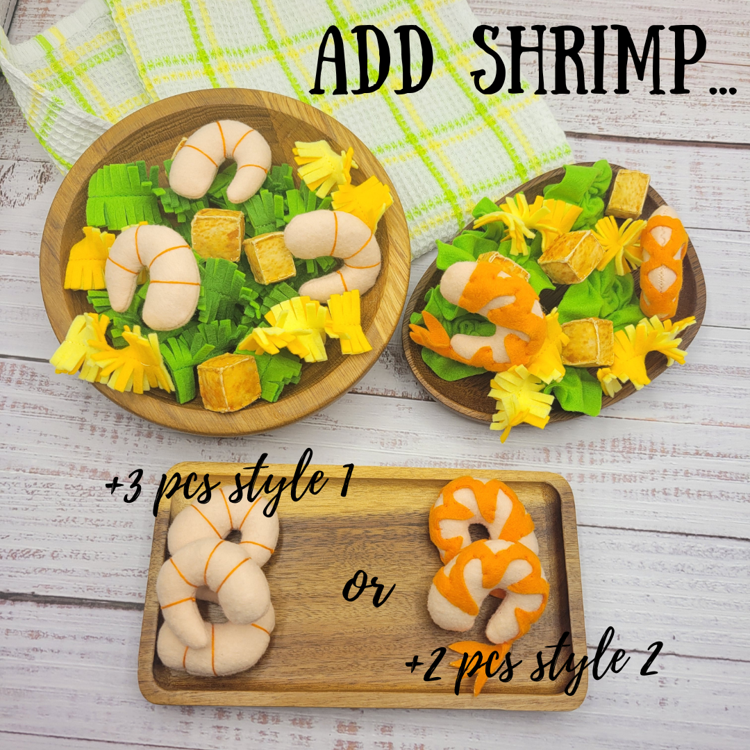 Wooden trays with shrimp and vegetable-shaped plush toy caesar salad on a wooden surface.