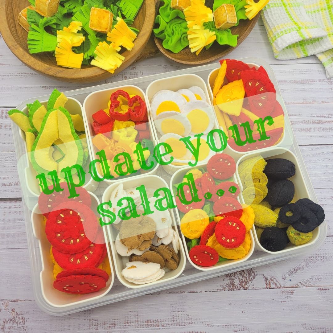 Colorful toy caesar salad set with various vegetables on a wooden surface.