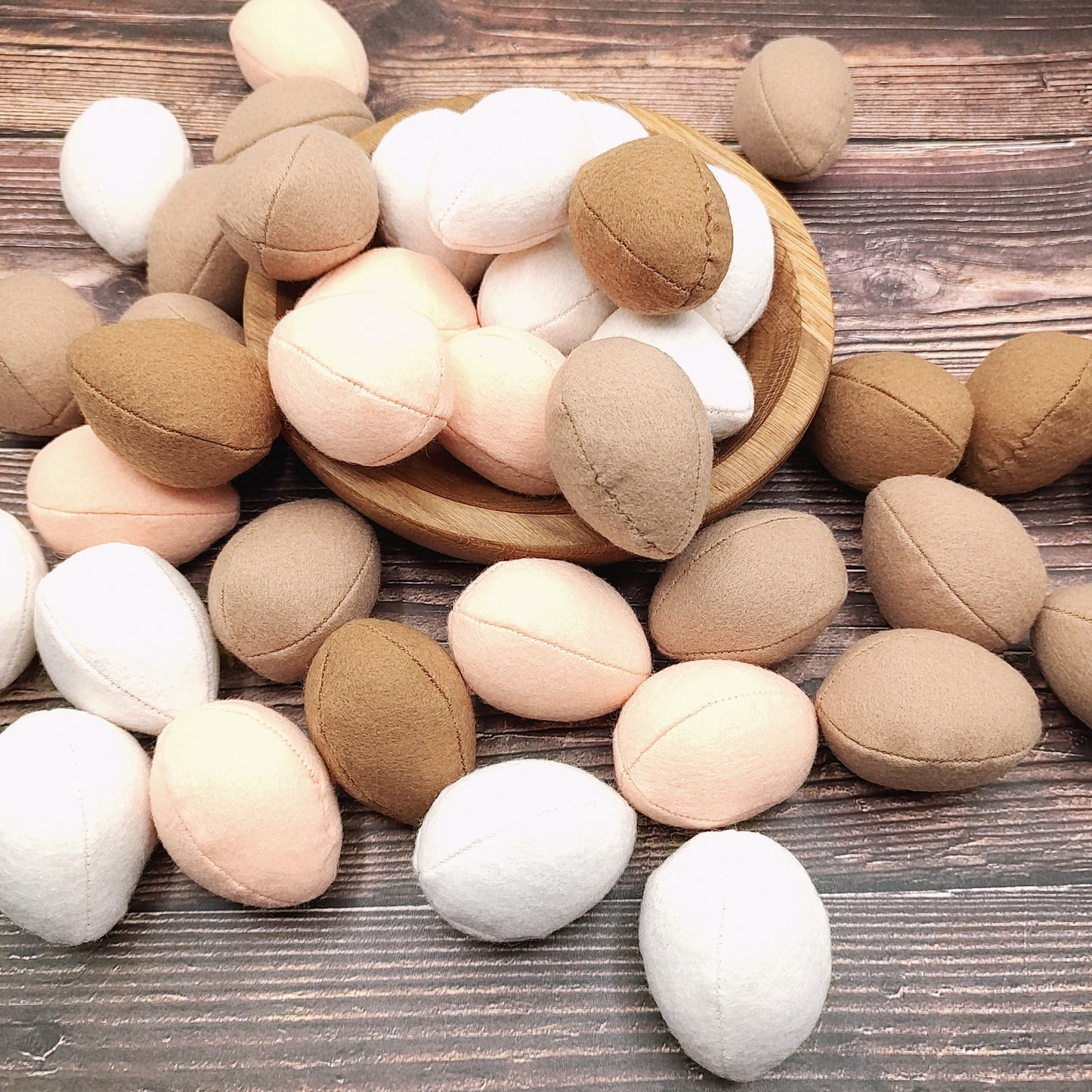 Wooden toys shaped like eggs on a wooden surface