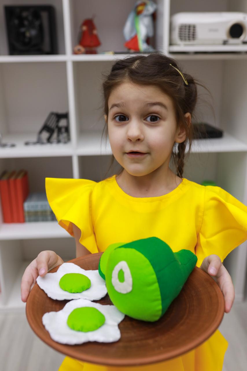 Children playing with green eggs and ham plush set