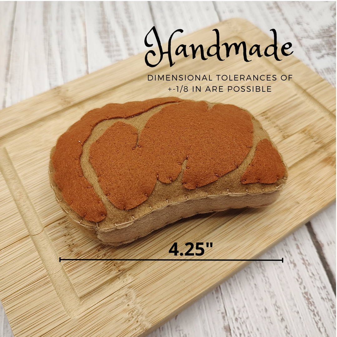 Handmade Plush Steak Toy for Kids with measurements on a wooden surface