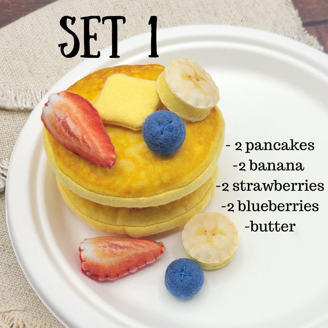 Stack of felt pancakes with fruit on a white plate, labeled with ingredients.