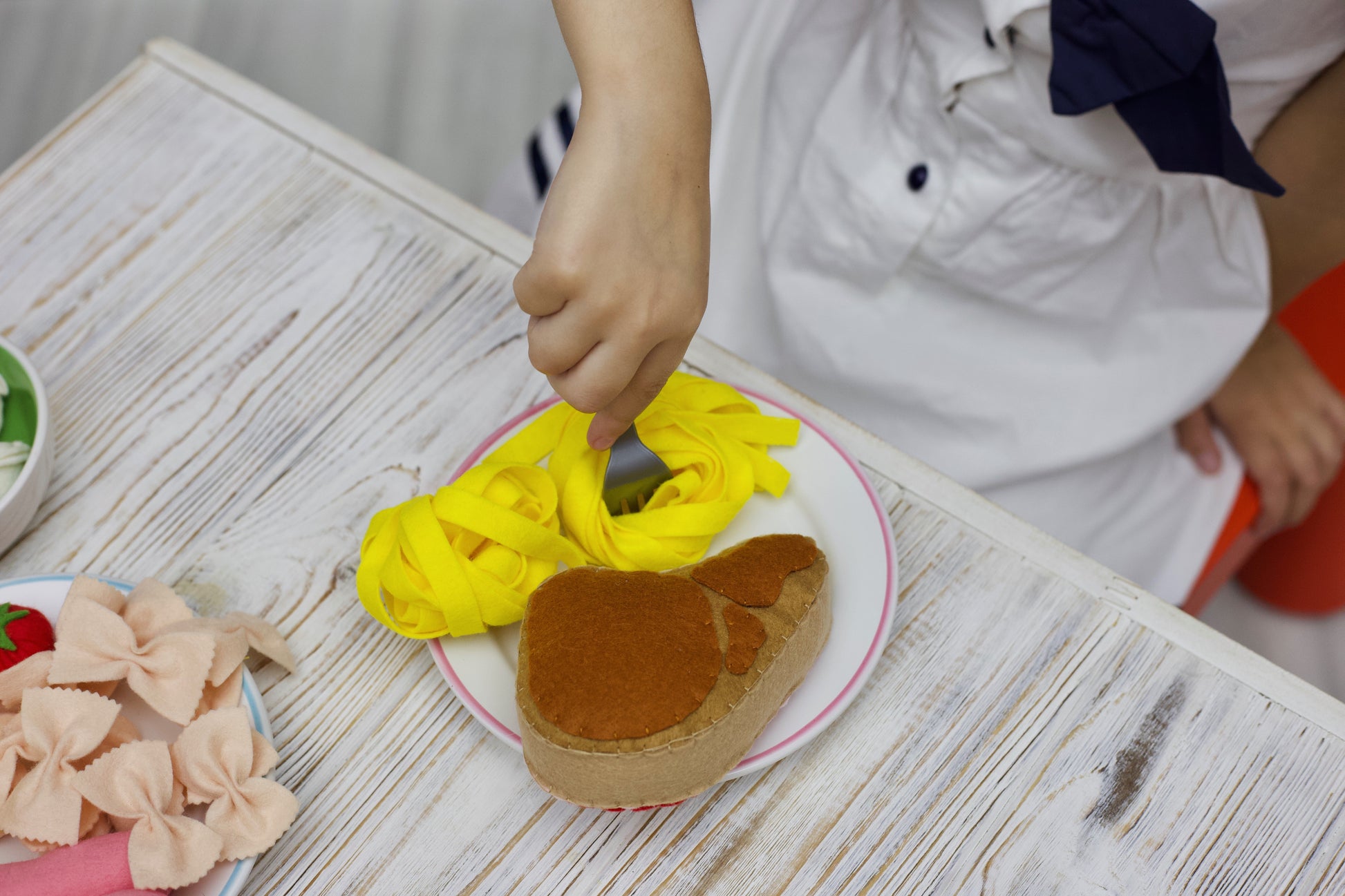 Felt pasta shapes pretend play by child