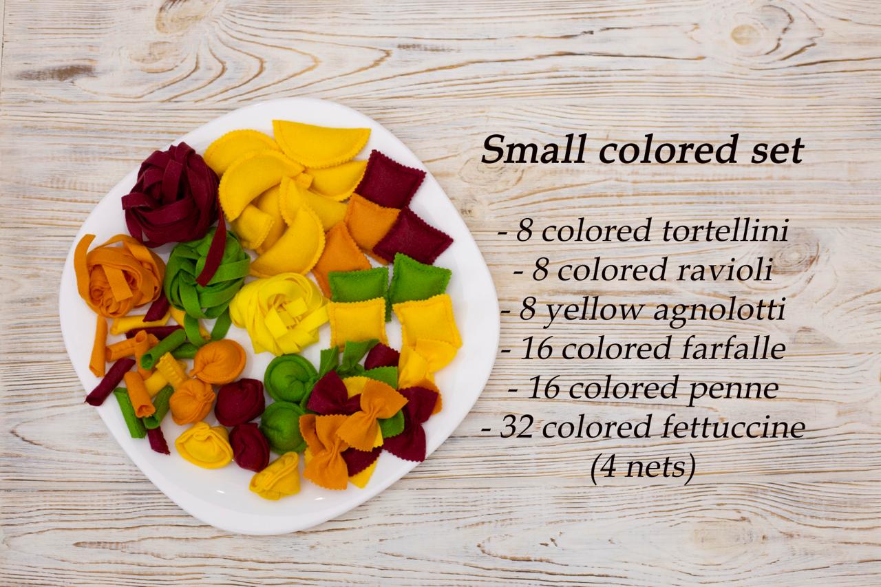 Assorted colored play food pasta on a white plate with text detailing the quantity of each type of pasta.