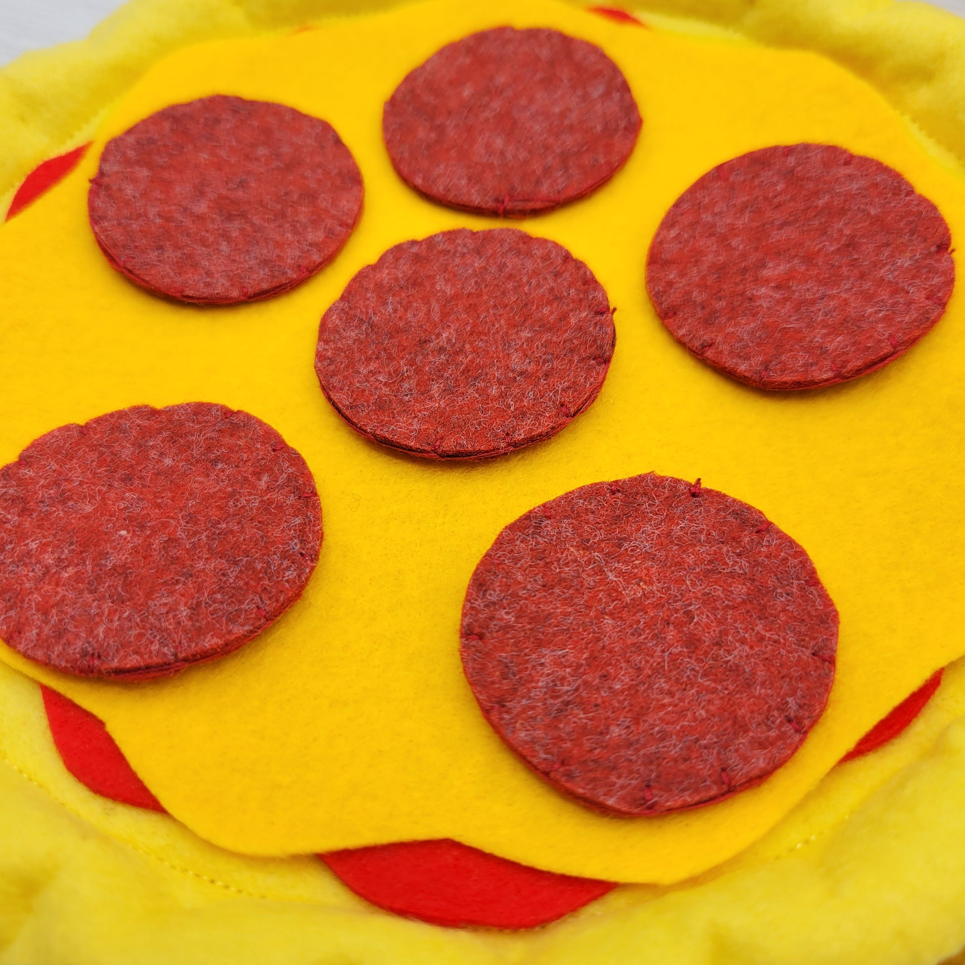 Plush pizza slice with pepperoni detail