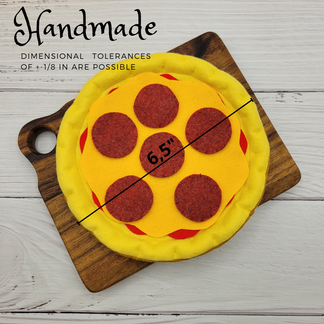 Felt pizza plush toy next to other play food items