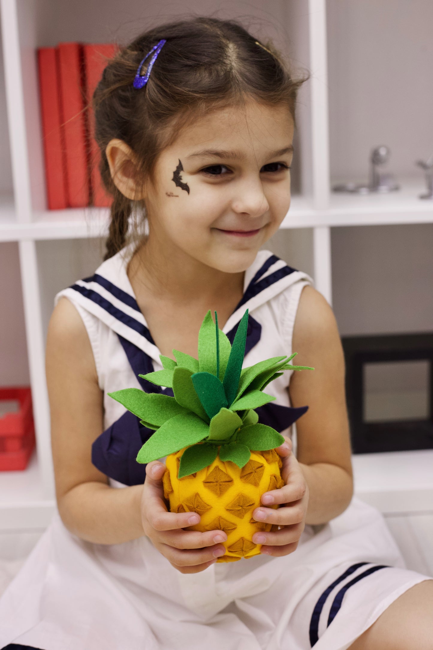 A girl with soft pineapple plush toy
