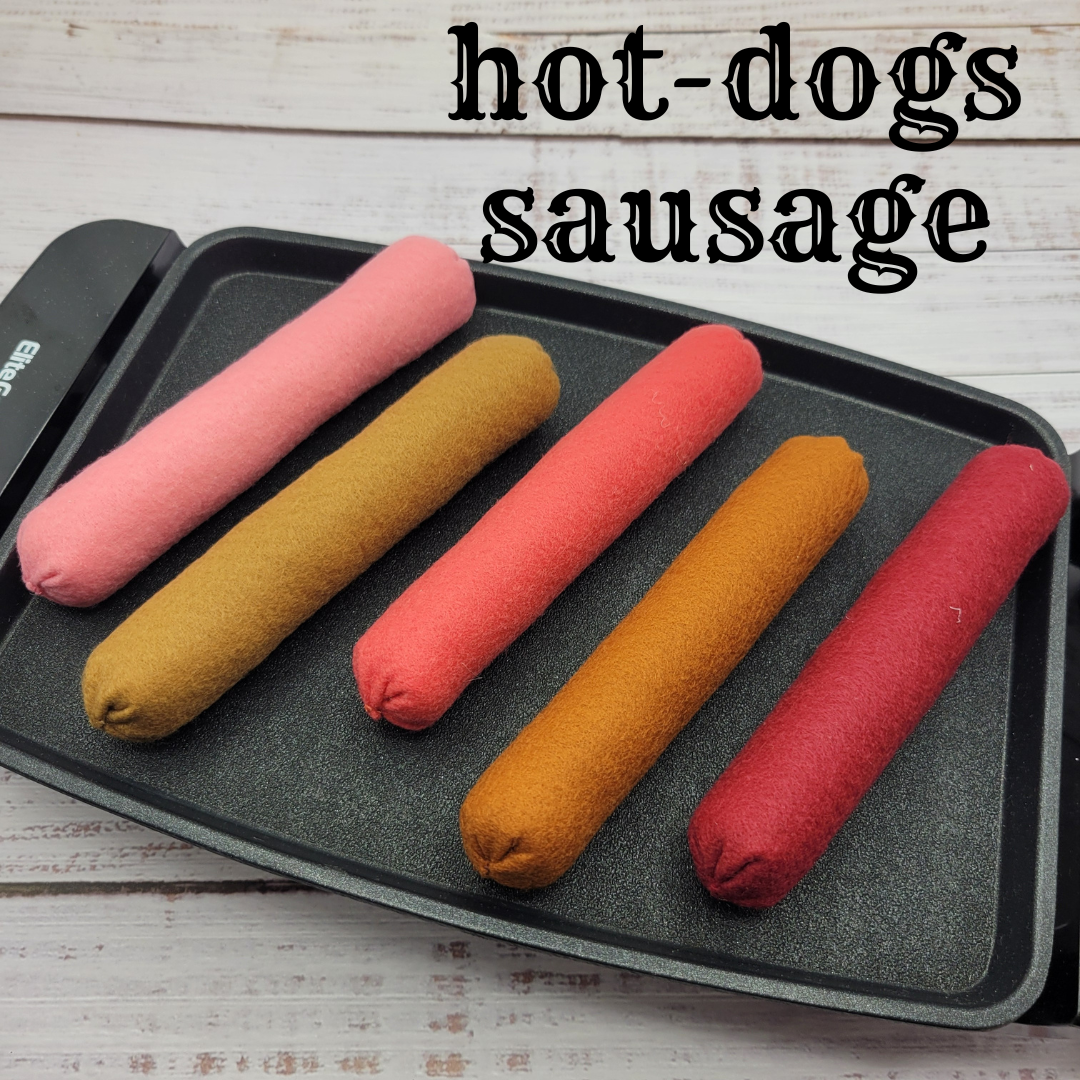 Colorful hot dog plush pretend play toys sausages on a baking tray with 'hot-dogs sausage' text above.