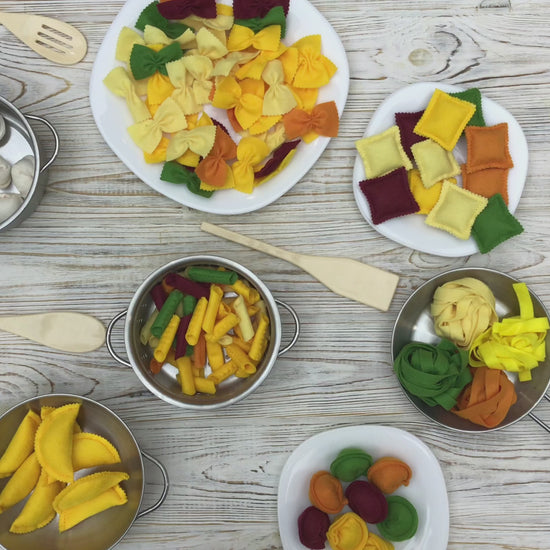 Plush pasta set displayed on toy plate for pretend play